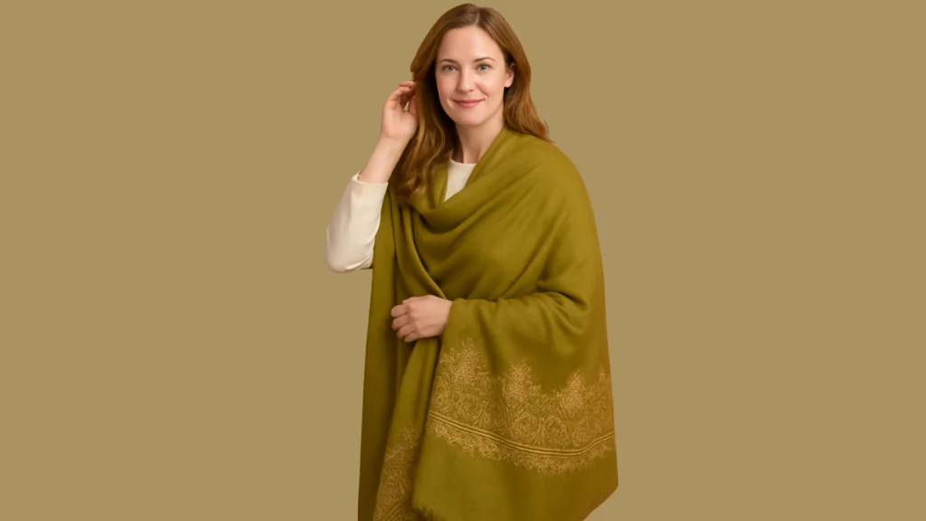 women wearing a handvowen kasmiri Pashmini Shawl in green and yellow tones