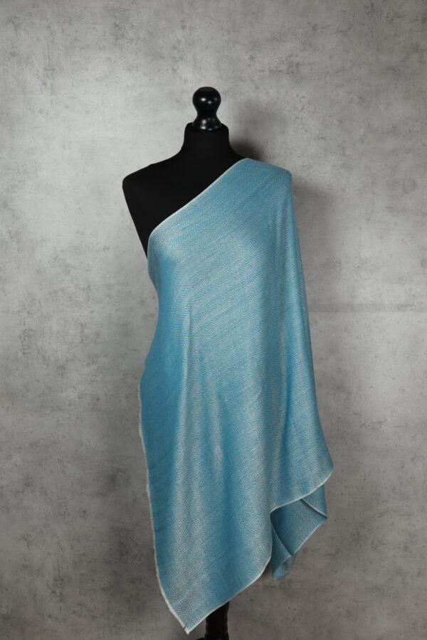 WhiteSpine Stole in sky, a breathable light stole crafted in refined herringbone for versatile styling.