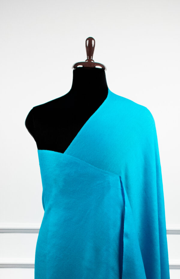 Bare Weave Shawls in sky, a wool silk shawl with plain weave design and a subtle sheen for elegant layering.
