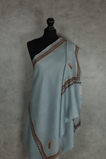 Fincrest Stole, an embroidered wool scarf in soft blue with traditional Kashmiri sozni embroidery along the border