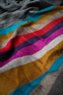 Reversible Stripes Shawl in Teal, a striped shawl featuring bold multicolored stripes and a subtle gradient, crafted from a wool and Tencel blend.