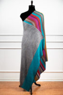 Reversible Stripes Shawl in Teal, a striped shawl featuring bold multicolored stripes and a subtle gradient, crafted from a wool and Tencel blend.
