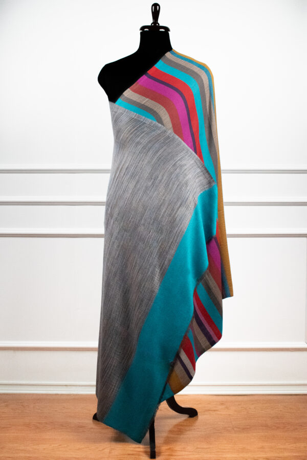 Reversible Stripes Shawl in Teal, a striped shawl featuring bold multicolored stripes and a subtle gradient, crafted from a wool and Tencel blend.