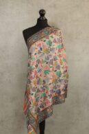 Royal Crest Stole in beige crafted as a wool paisley stole with intricate embroidery and fluid texture.