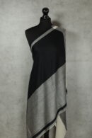 Harmony Weave Stole in Black & White, a herringbone stole with breathable warmth and flowing elegance.