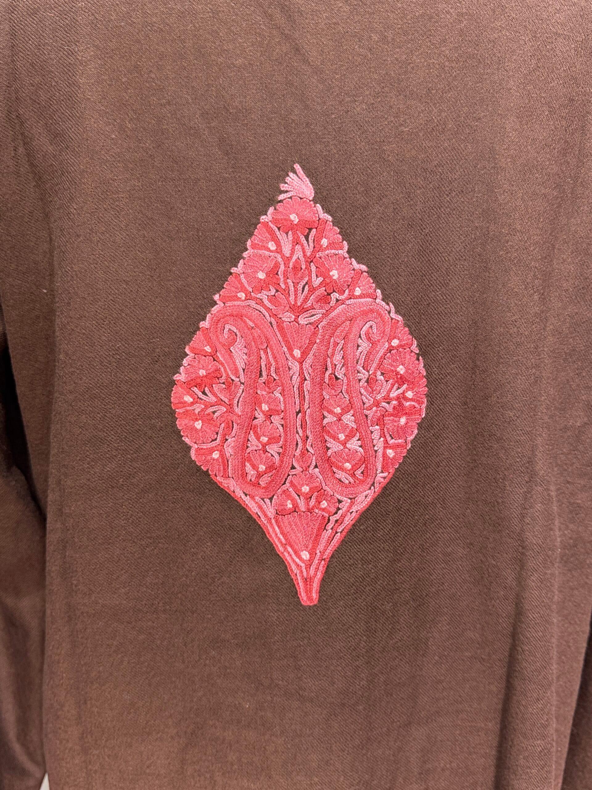A pink chain-stitch boteh embroidered on the back of a brown wool jacket